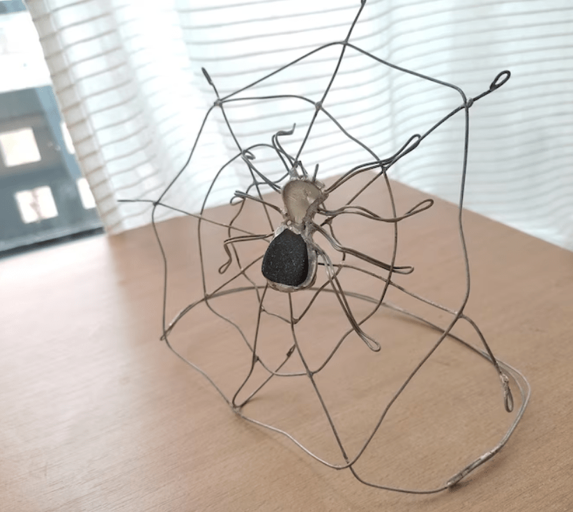 Sea glass spider on a spiderweb table suncatcher, teal-brownish glass scary home decor